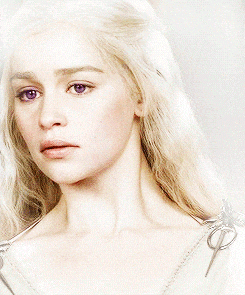 a woman with blonde hair has purple eyes