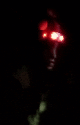 a person with a red light on their head with the letter t on it