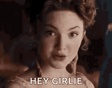a woman in a dress is saying `` hey girlie '' .