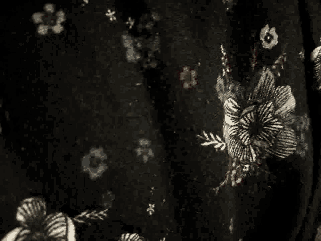 a close up of a black fabric with a floral pattern on it .