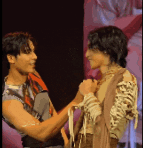 a man in a skeleton costume holds another man 's arm