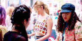 a group of young women are standing in a crowd .