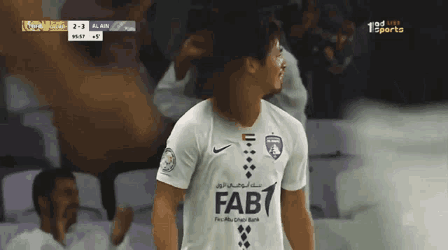 a soccer player wearing a white shirt with fab on it