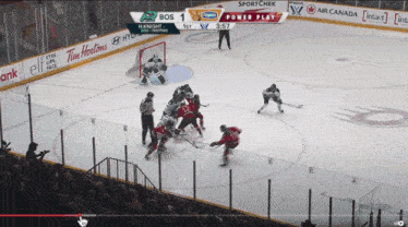 a hockey game is being played with ads for tim hortons