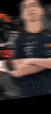 a blurry picture of a man 's face and arm