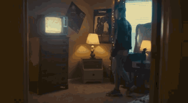 a room with a dresser and a lamp and a poster on the wall that says ' amanda ' on it