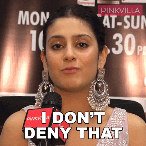 a woman speaking into a microphone with the words " i don 't deny that " on her face