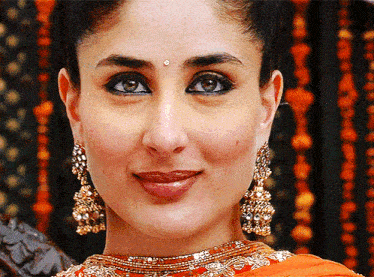 a close up of a woman wearing gold earrings