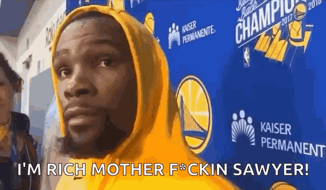 a man wearing a yellow hoodie says i 'm rich mother f * cking sawyer .