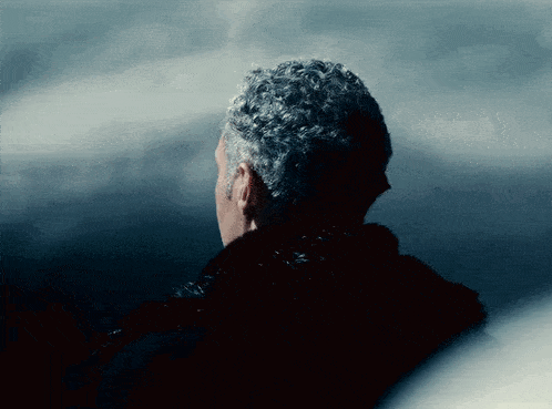 the back of a man 's head is shown with a dark background