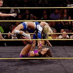 two women are wrestling in a ring with a crowd watching and the words sky 5 in the corner