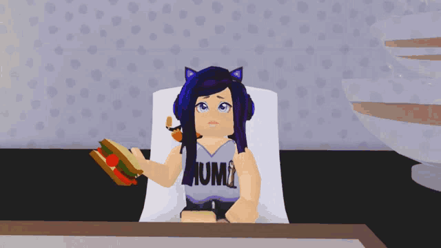 a girl in a purple shirt that says mum is holding a sandwich in her hand