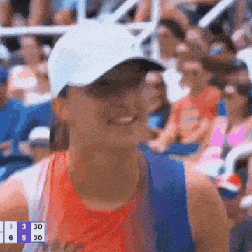 a woman wearing a white hat and sunglasses is smiling in front of a scoreboard that says 3 30 6 30