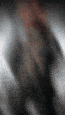 a blurred image of a person 's face with a gray and white background