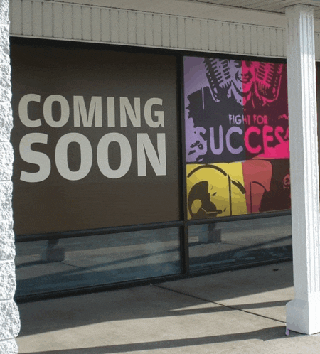 a sign that says coming soon is on a window