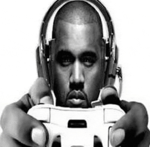 a man wearing headphones is holding a video game controller
