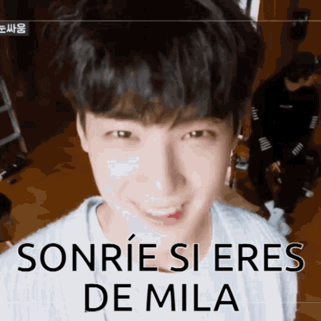 a close up of a person 's face with the words sonrie si eres de mila written on the bottom