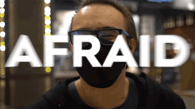 a man wearing glasses and a mask with the word afraid in front of him
