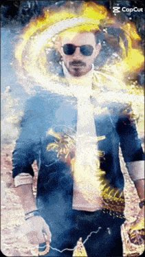 a man wearing sunglasses is surrounded by a fire ring and the word capcut is on the bottom right