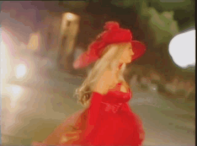 a woman in a red dress and red hat