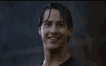 a man with wet hair is giving a thumbs up