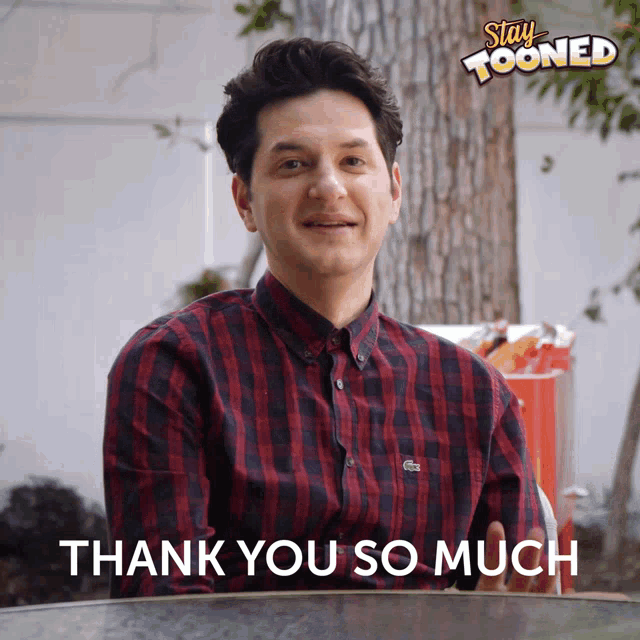 a man wearing a plaid shirt says " thank you so much "