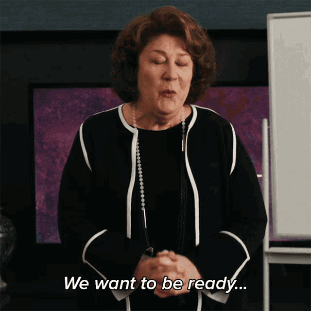 a woman says " we want to be ready " in front of a whiteboard