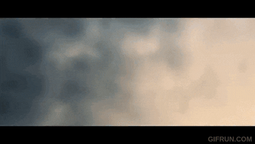 a gif of a cloudy sky with the website gifrun.com visible in the corner