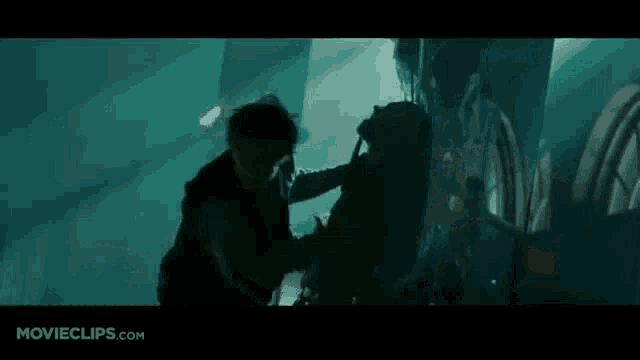 a man and a woman are fighting in a dark room .