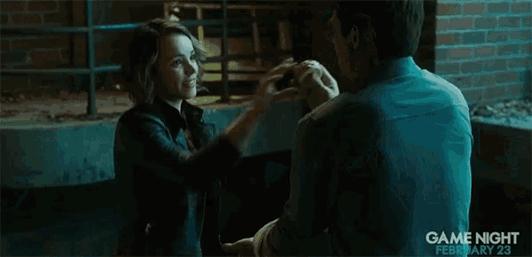 a man is holding another man 's hand in a scene from game night