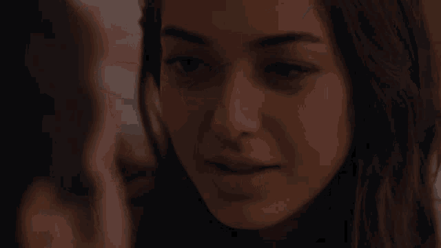 a close up of a man 's face with a woman behind him
