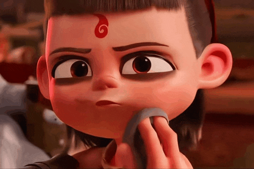 a close up of a cartoon character with a red swirl on his head