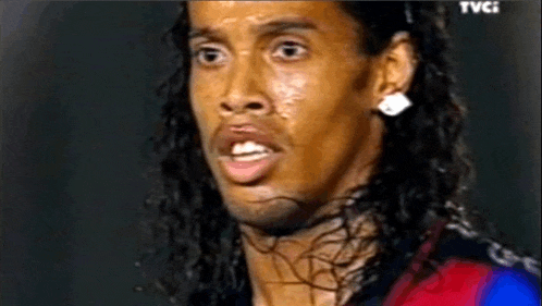 a close up of a soccer player 's face with a tear coming out of his eye .