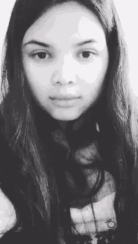 a black and white photo of a woman with long hair and a calvin klein shirt
