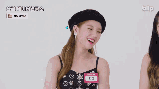 a girl wearing a name tag that says blip