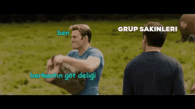 two men are standing in a grassy field and one of them is carrying a bag that says " ben "
