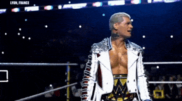 a man in a white jacket is standing in a ring with lyon france written on the bottom