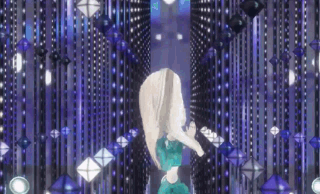 a woman in a green dress is dancing in front of a purple background with a lot of lights .