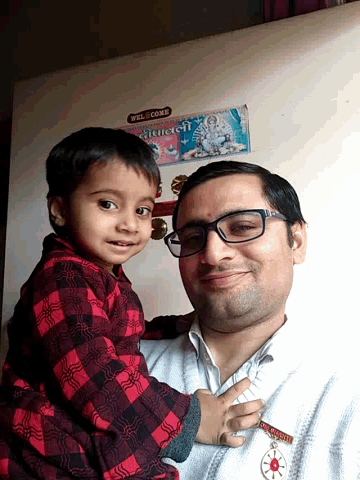 a man and a child are posing for a picture with a sign that says well come