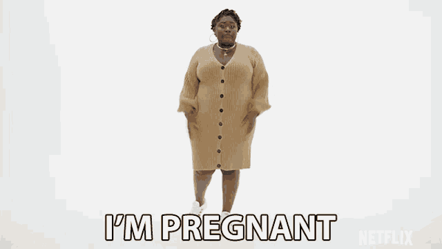 a woman in a sweater dress says i 'm pregnant on a white background