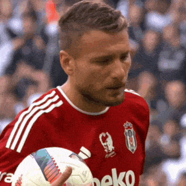 a man in a beko jersey holds a ball