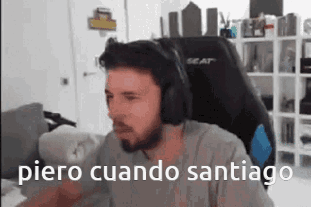 a man wearing headphones is sitting in a chair with the words piero cuando santiago above him