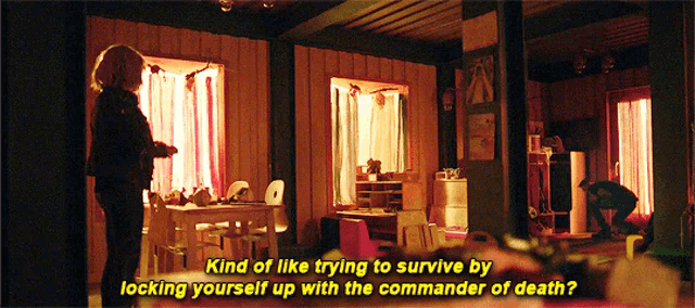 a woman standing in a room with the words kind of like trying to survive by locking yourself up