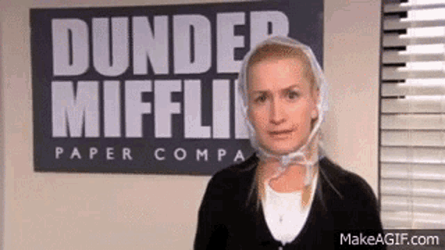 a woman with a plastic bag on her head is standing in front of a sign that says `` dunder mifflin paper company '' .