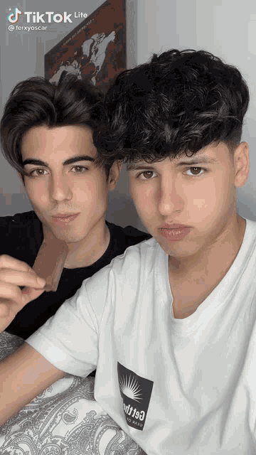two young men are posing for a picture with tiktok lite written on the bottom