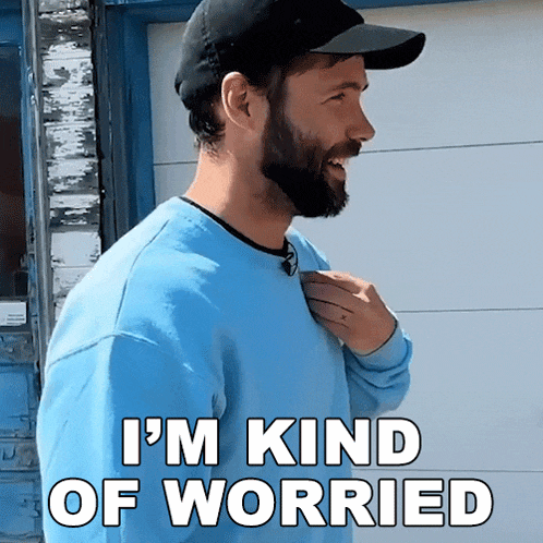a man with a beard is wearing a blue sweater and a hat and says i 'm kind of worried
