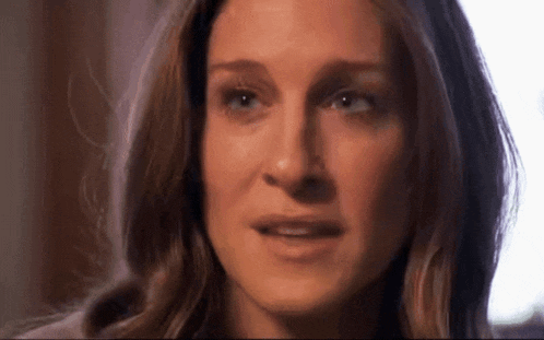 a close up of a woman 's face with a slight smile on her face .