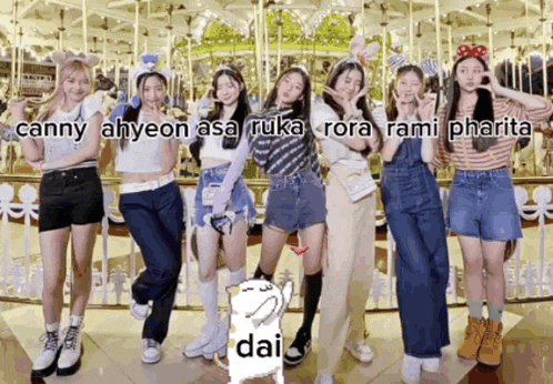 a group of girls posing in front of a merry go round with dai written on the bottom