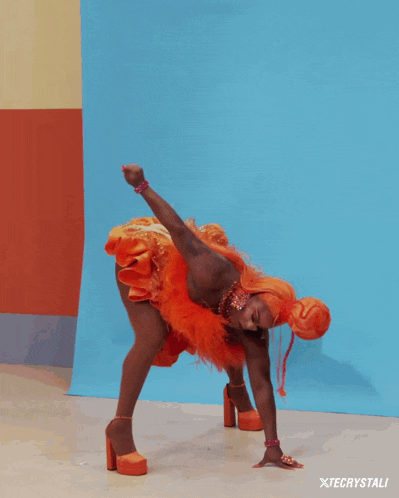 a woman in a red dress is doing a handstand in front of xtecrystali