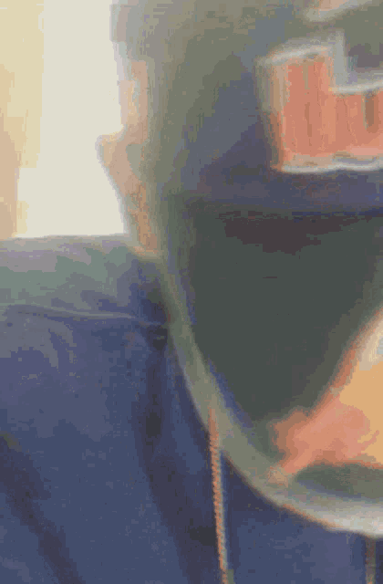 a blurry picture of a person wearing a hat with the letter r on it